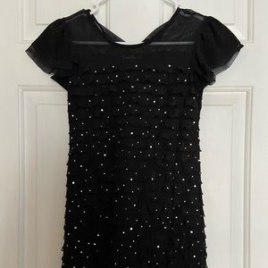 Girl’s sparkly black dress.